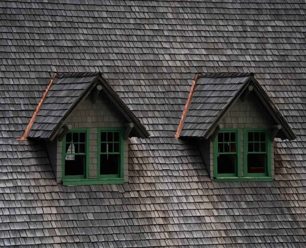 Dormers on a shingle roof in Miami Gardens, FL, where step flashing and kickout flashing carry water past the walls