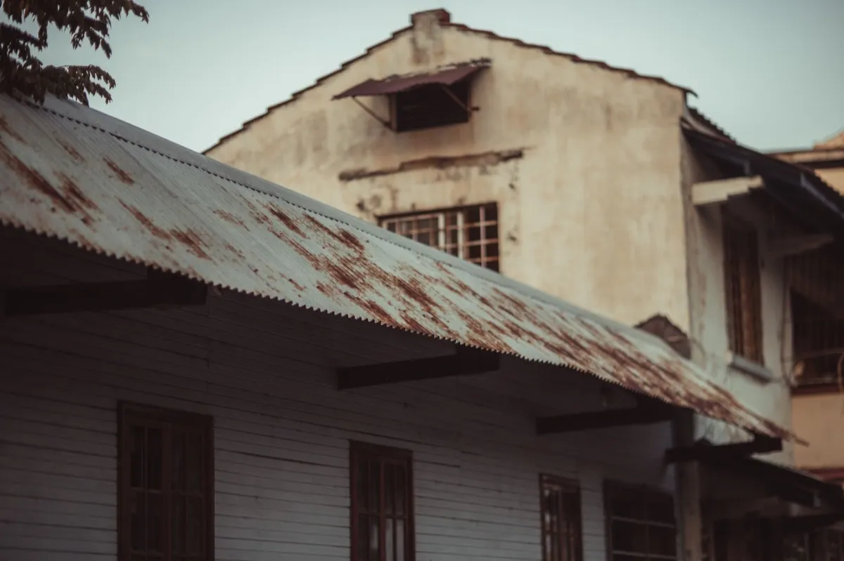 Weathered exposed-fastener metal roof on an outbuilding near Miami Gardens, FL